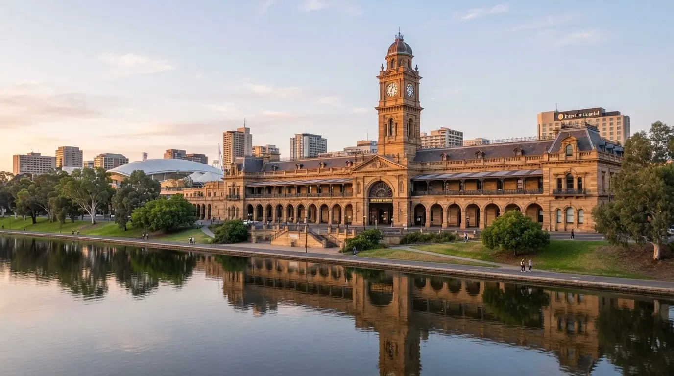 Wide exterior shot of the heritage sandstone building showing the original railway station architecture, River Torrens in the foreground